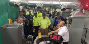A Group Of People Standing Around A Plane