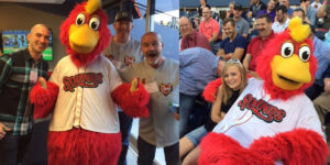 A Group Of People Standing In Front Of A Large Teddy Bear