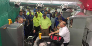 A Group Of People Standing Around A Plane
