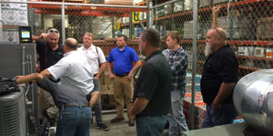 A Group Of People Standing In Front Of A Store