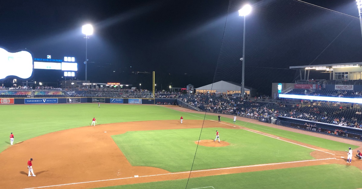 a group of baseball players standing next to home plate