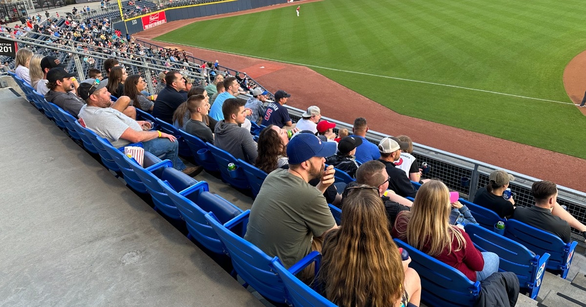 a group of people sitting in chairs in front of a crowd