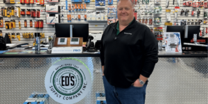 A Man Standing In Front Of A Store