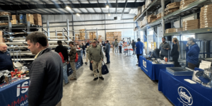 A Group Of People Standing In A Room
