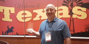 a man holding a sign posing for the camera