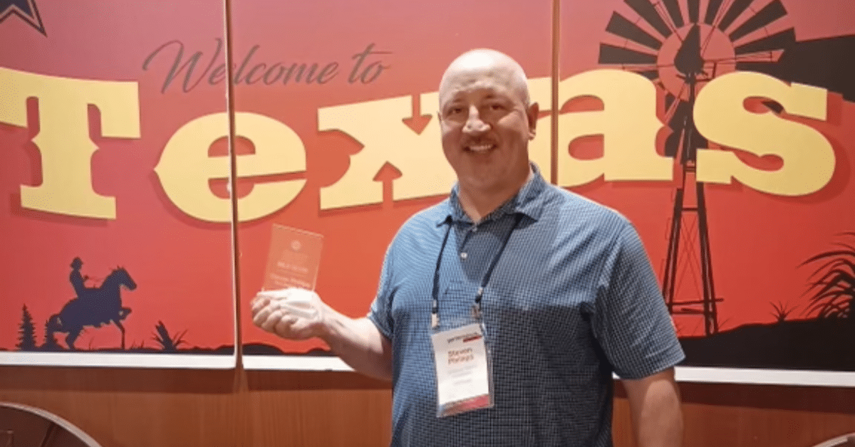 a man holding a sign posing for the camera